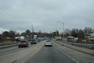 Main and Washington Streets combine ahead of the Indian River. SR 24 Business spans the waterway on a bridge built in 1981.