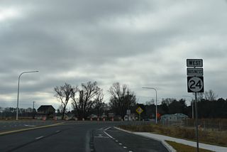 John J. Williams Highway was realigned to turn south at a signalized intersection with Hollyville Road as part of the construction for the North Millsboro Bypass. The first shield for SR 24 Business west follows.