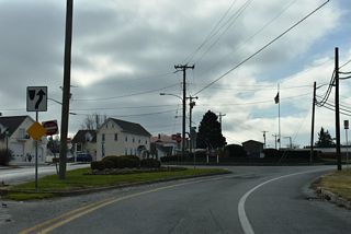 Upon crossing Millsboro Pond, SR 24 Business partitions into the couplet of Washington Street westbound and Main Street eastbound.
