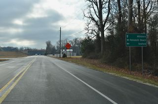 An access road connects SR 30 (Gravel Hill Road) with SR 24 along the North Millsboro Bypass. Linking SR 20 west to Seaford with SR 24 east to Rehoboth Beach, the two-lane, controlled access highway runs north of Millsboro.
