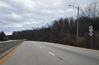 A concrete barrier separates traffic along SR 71/896 south from Brennan Boulevard south to the Summit Bridge.