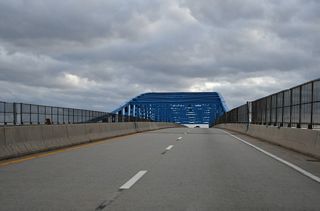 A continuous steel thru truss bridge, the Summit Bridge replaced a lift bridge at the nearby community of Summit Bridge.
