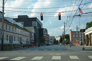 An AETNA fire station, several row homes and the Grand Opera House Apartment Building line the final block of Academy Street.