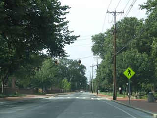 A set of pedestrian flashers along Academy Street north near Lovett Avenue.