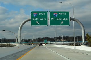 Passing over SR 4 (Madison / Monroe Streets), the elevated ramps from MLK Boulevard partition for I-95 north to U.S. 202 (Concord Pike) and Philadelphia and I-95 south to I-295 and Baltimore.