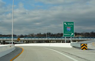 Passing over SR 4 (Madison / Monroe Streets), the elevated ramps from MLK Boulevard partition for I-95 north to U.S. 202 (Concord Pike) and Philadelphia and I-95 south to I-295 and Baltimore.