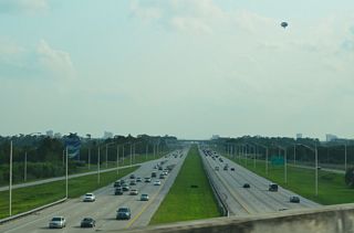 Interstate 4 passes below the Central Florida Parkway flyover with eight overall lanes. Section 2 of the I-4 Beyond the Ultimate megaproject expands the exchange here with new ramps leading to I-4 east and from I-4 west.