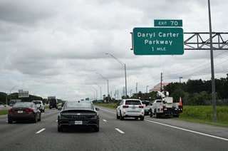 Interstate 4 next meets Daryl Carter Parkway at a diverging diamond interchange (Exit 70). Daryl Carter Parkway is named after the Central Florida land investor and developer.