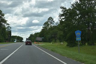 Westbound SR 16 at CR 315 south. CR 315 travels through vastly undeveloped rural areas to Sharron Road and Belmore Wildlife Management Area. CR 315 west along Sharron Road is unpaved.