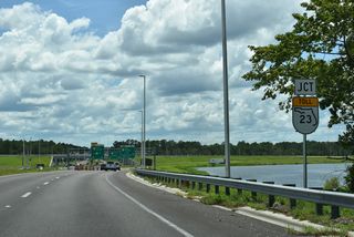 Curving southwest, U.S. 17 spans a CSX Railroad line ahead of the diamond interchange (Exit 13) with the First Coast Expressway.