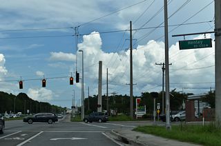 The commercialized stretch along SR 21 continues northeast from Brannan Field Road to CR 220A (Jennings Road) west and Henley Road south. Henley Road is CR 739 south from CR 220 at Rattlesnake Bend to CR 218 at Asbury Lake.
