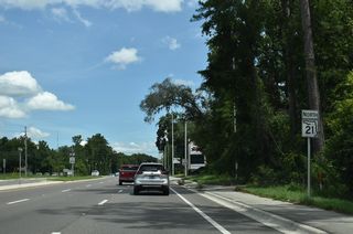 SR 21 reassurance marker posted north of the signal with Long Bay Road north and Lee Drive N east.