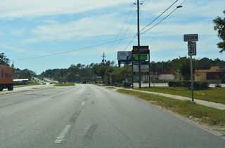 Southwest from CR 218, SR 21 transitions from a commercial boulevard into a rural highway.