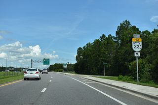 The first of two entrance ramps for SR 23 (First Coast Expressway) northbound from Challenger Drive joins the toll road beyond the Whisper Creek subdivision.