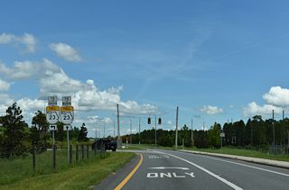 Oakleaf Plantation Parkway ties into the First Coast Expressway frontage road system east from the Oakleaf Plantation development. Challenger Drive ends here at the entrance ramp for SR 23 northbound.