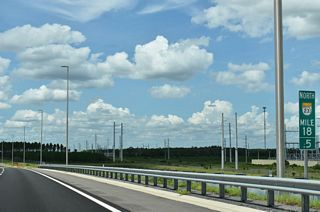 A transmission corridor parallels SR 23 north ahead of Exit 20 to SR 16. SR 16 branches west from U.S. 17 in Green Cove Springs to meets the toll road ahead of Penney Farms.