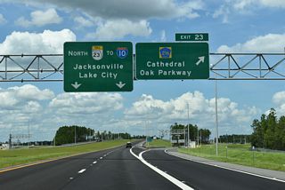 Signed as CR 216 at Exit 23, Cathedral Oak Parkway extends west to a roundabout with CR 218 north of Penney Farms and east to CR 315 near Green Cove Springs.