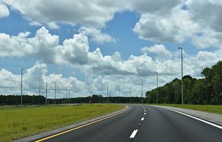 The First Coast Expressway curves eastward again ahead of CR 15A (Oakridge Avenue).