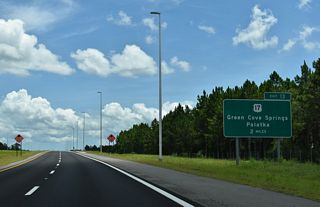 U.S. 17 angles northeast from CR 15A (Oakridge Road) to meet the First Coast Expressway at a diamond interchange (Exit 13) in two miles.