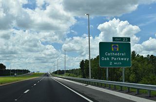 Resuming a southward course, SR 23 advances two miles to the DDI (Exit 23) with CR 216 (Cathedral Pak Parkway).