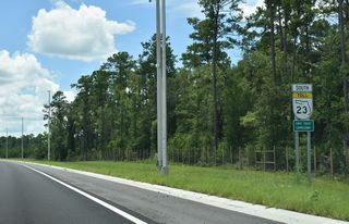 Curving southeast from CR 220, SR 23 travels by protected areas in Rideout Point Preserve.