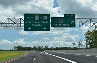 Henley Road constitutes a five lane suburban boulevard north to CR 220 (Doctors Inlet Road) at Rattlesnake Bend and south through the Asbury Lake community to CR 218.