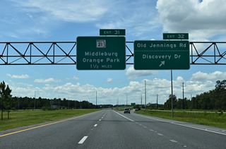 Exit 32 leaves SR 23 south for CR 220A (Old Jennings Road), Challenger Drive north and Branan Field Road (old SR 23). The First Coast Expressway mainline extends another 1.75 miles to Exit 31 / SR 21 (Blanding Boulevard).