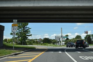 The westbound roadway for Oakleaf Plantation Parkway crosses the eastbound roadway at Discovery Drive adjacent to the southbound lanes along SR 23.