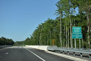 SR 50 makes a gradual northeasterly turn ahead of the Little Withlacoochee River and Sumter County line.