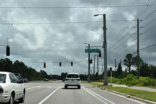 River Glen Boulevard meets CR 54 at a signalized intersection across from a future suburban boulevard leading south to the Valencia Ridge development and SR 56.