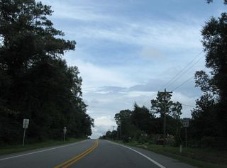 CR 85A returns to SR 85 northbound ahead of this shield assembly in Laure Hill.