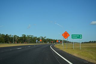 The distance sign formerly posted where SR 123 intersected SR 85 was carbon copied. Florala, Alabama is 40 miles to the northeast instead of 38.