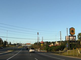 An array of traveler services line SR 85 (Ferndon Boulevard) at the diamond interchange (Exit 56) with Interstate 10. Planned six lane expansion of SR 85 north from P.J. Adams Parkway to I-10 includes reconfiguring this exchange into a DDI.