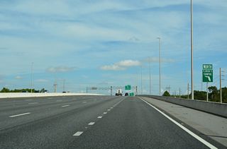 This confirming marker precedes an underpass for the CSX Railroad line. Started in April 2017, a $176 million construction project expanded the toll road from four to eight lanes, with two express lanes in each direction, from Osceola Parkway north to the Beachline Expressway.4