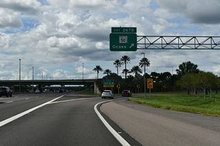 A trumpet interchange (Exit 267 B) follows on the Turnpike northbound with an access road linking the toll road with parallel SR 50 (W Colonial Drive).