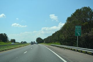 Northbound reassurance shield posted by the J.W. Jones Road underpass. Rural land on the south side of the Turnpike was turned over for development of the Oakland Trails subdivisions in 2017.