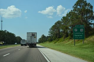 Advancing northwest, next along the Turnpike is the trumpet interchange (Exit 285) for U.S. 27 (Claude Pepper Memorial Highway) and SR 19 (Howey Road) in north Groveland. A greenout replaced Clermont with Tavaras on this panel.