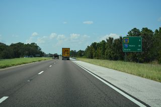 Lake County Road 470 converges with the Turnpike in six miles at a formerly rural area of west Leesburg. The Okahumpka Service Plaza follows two miles further northwest.