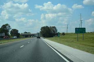 CR 468 passes over the toll road beyond this distance sign 29 miles from Ocala. With the Villages community expanding southward into Sumter County, an interchange was proposed in 2009 at CR 468 to serve new development. The county road was four laned and grading was completed for possible ramps, but plans for the exchange were abandoned in 2017.3