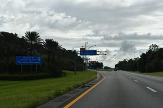 Southbound at the left exit for the Okahumpka Service Plaza on Florida's Turnpike. The facility provides fuel, food and tourist information.