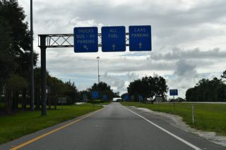 Southbound at the left exit for the Okahumpka Service Plaza on Florida&#039;s Turnpike. The facility provides fuel, food and tourist information.