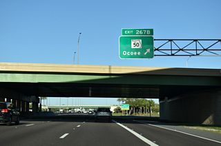 Entering the trumpet interchange (Exit 267 B) with the access road north to SR 50 (W Colonial Drive). SR 50 extends across the city of Orlando to Bithlo and Christmas in eastern Orange County, and overall to Titusville.