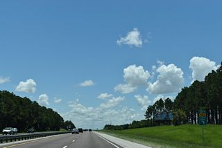 Subdivisions abut both sides of Florida's Turnpike on the ensuing stretch southeast by Blacks Still Lake.
