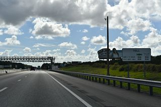 The mainline all electronic tolling (AET) gantry at mile marker 287.5 replaced the Leesburg toll plaza. Located at mile marker 288, the original toll plaza was demolished in 2021.