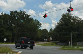 SR 21 is unmarked at the north end of CR 215. The state road expands to a four lane, divided arterial northeast from CR 215 into Middleburg.
