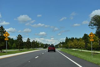 Cathedral Oak Parkway ties into CR 218 at a roundabout adjacent to the Amberly development.