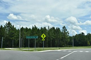 Construction on Cathedral Oak Parkway got underway in August 2023 (Clay County, Florida, 2025). The four lane arterial was built to accommodate anticipated suburban development, as several stub intersections were built into the roadway design.
