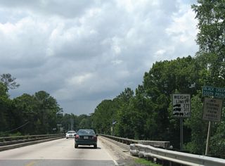 Crossing the South Fork of the Black Creek on Clay County Road 218 westbound. Built in the 1960s, the two lane span was closed temporarily on September 19, 2017 for safety repairs relating to erosion and scouring at the bridge base and supports.&sup1; A four lane replacement was built in 2022.