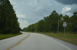 SR 230 curves north from West Gate Road to Kingsley Village.