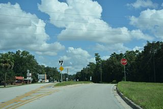 Curving north around Lake Kerr, CR 314 ties into SR 19 at a wye intersection adjacent to NE 132nd Place. The state road is not signed from the county road.